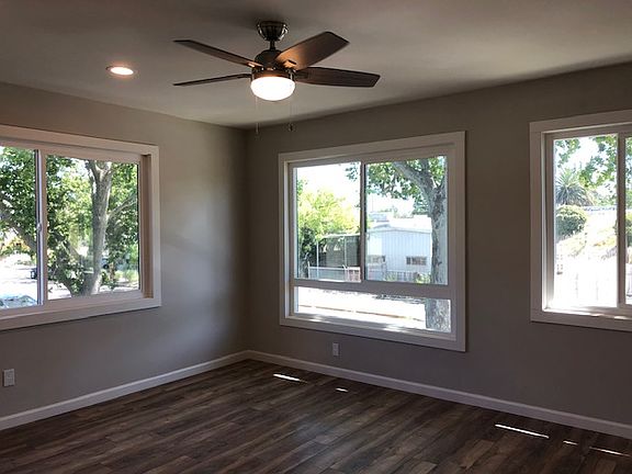 Top floor bedrooms facing U St look onto the large sycamore tree, have wood laminate flooring, large windows, ceiling fan, two tone paint, good size closets