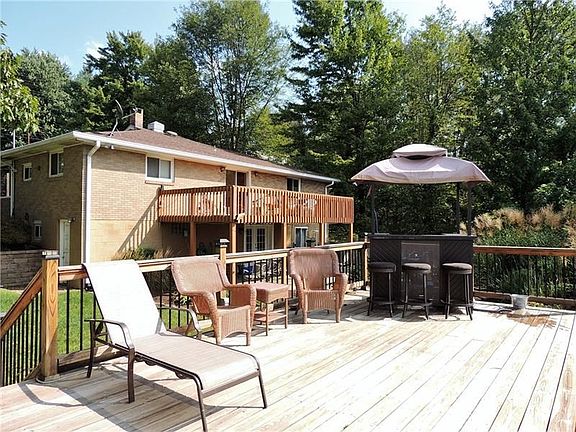 There is plenty of room for family and guests on the poolside deck.  This view also shows the spacious deck off of the back of t