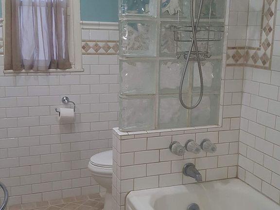 Bathroom with storage above the toilet.