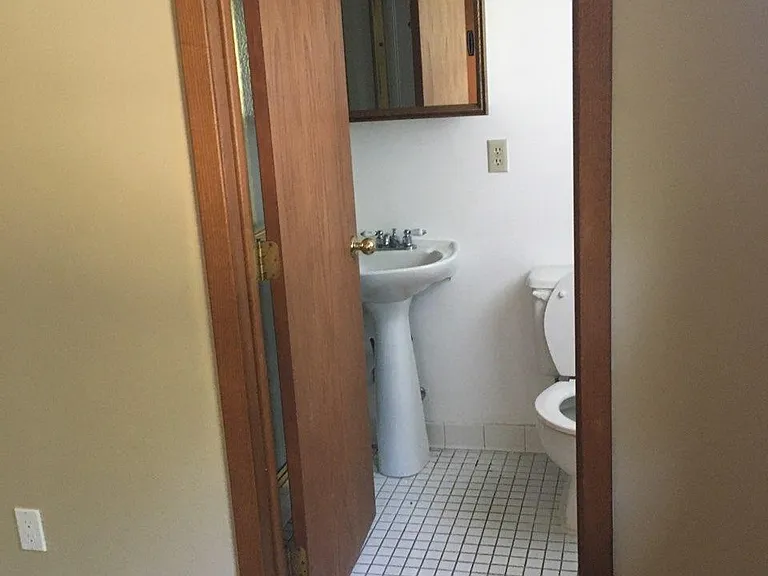 basement bathroom with shower and window to backyard