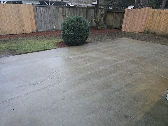Large back patio for grilling. Side right fence completion 1/16/25.
