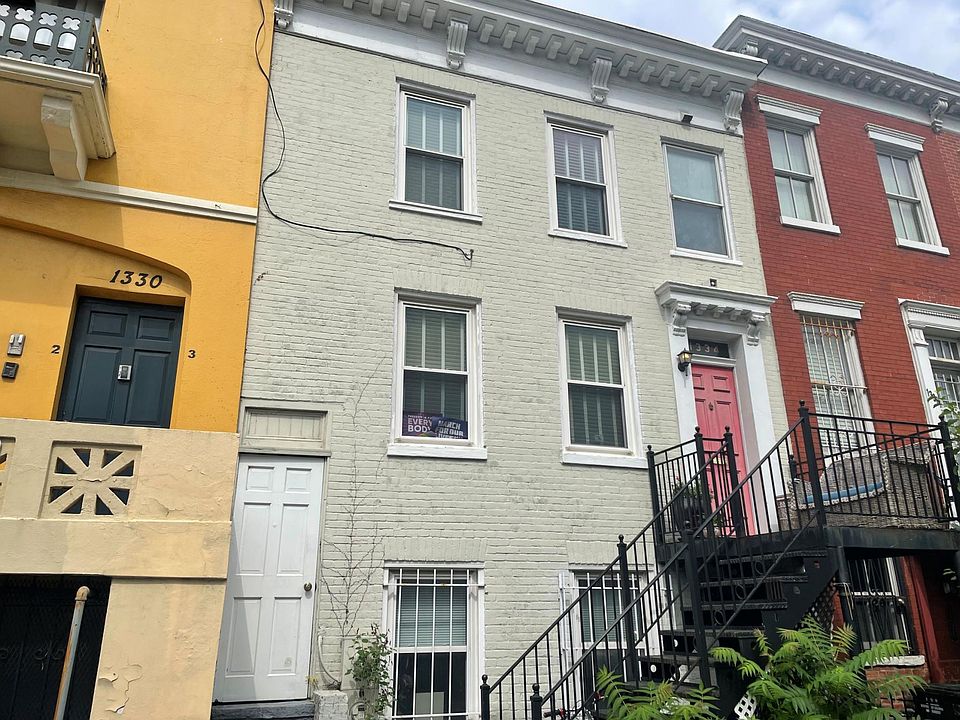 The red door is to the house, the white door to storage