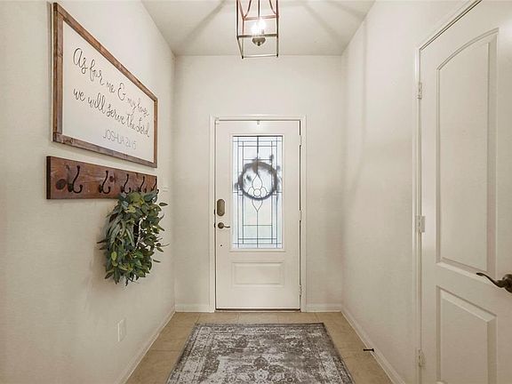 Just inside the front door is a welcoming formal entry with a simple yet elegant fixture.