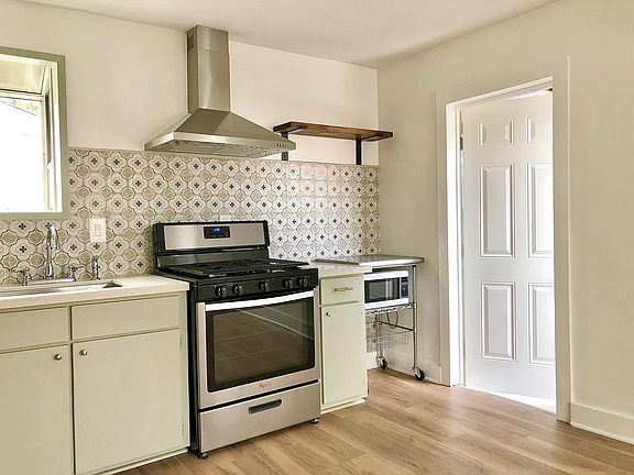 Kitchen with door to outdoor breezeway back patio.