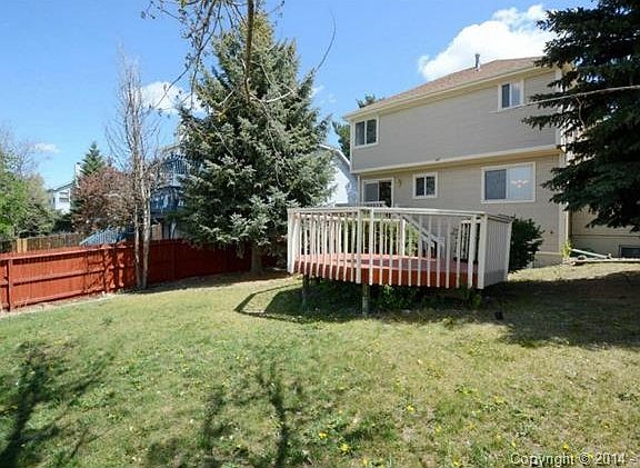 Large fenced backyard with matured trees