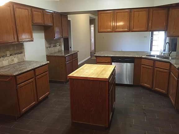 Kitchen. Granite countertops, center island, opens to livin