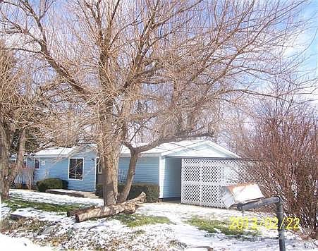 Front view of home from the S.  Trees are great shade in the spring, summer and fall months, very pretty.