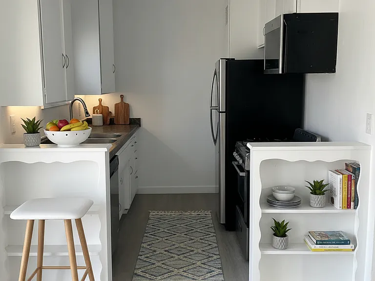 Kitchen with gas stove, fridge and over the range microwave