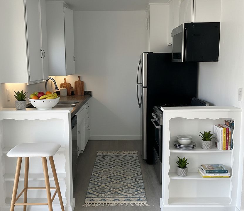 Kitchen with gas stove, fridge and over the range microwave