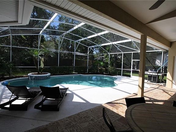 Spacious Lanai Overlooking Sparkling Pool with Tranquil Spillover Feature