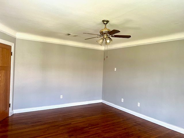 Living room with cove ceilings and solid oak floors.