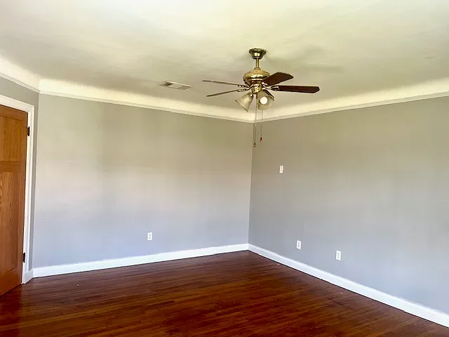 Living room with cove ceilings and solid oak floors.