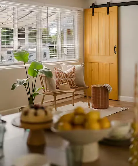 Bright, modern dining space with a warm wooden table and chairs, filled with natural light_perfect for cozy meals or entertaining in style.