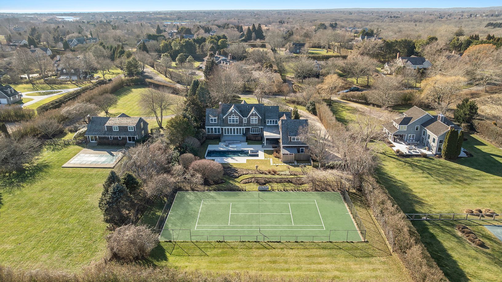 View of house and tennis from the back
