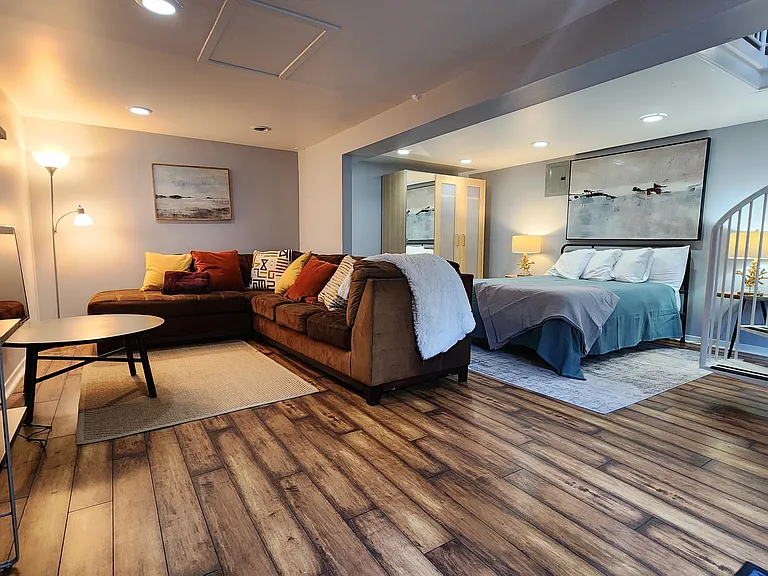 The unit is being delivered unfurnished, and there are limitless ways to configure this large downstairs flexspace/bedroom.