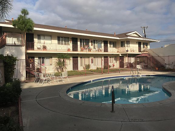 Courtyard with pool. The unit is on the right side ground floor, Laundry room is on the right at the bottom of the stairs