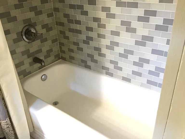 The private ensuite bath features a full-size soaking tub and shower.