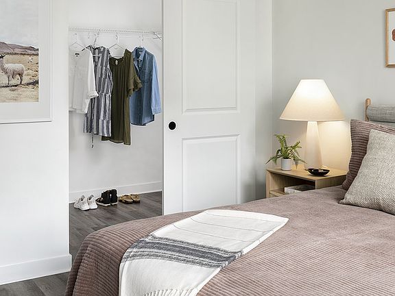 Spacious apartment Bedroom with Large Closet and Wood Floors.