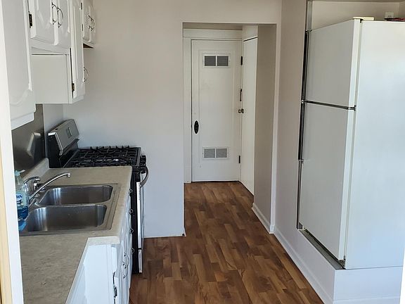 Kitchen from 3 season room in front.