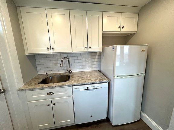 Granite Counter Tops, Gooseneck Faucet, Subway Tile Backsplash & Dishwasher.