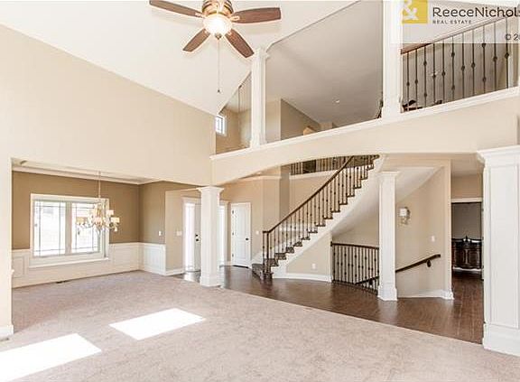 VIEW FROM GREAT ROOM OF FORMAL DINING ROOM, CIRCULAR STAIRCASE AND LOFT ABOVE