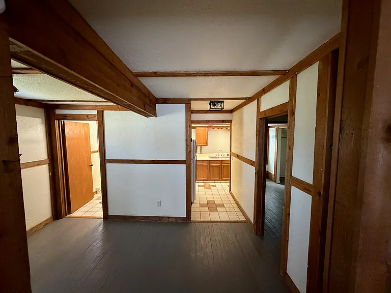 dining room area bedroom door right, kitchen center, bathroom door left