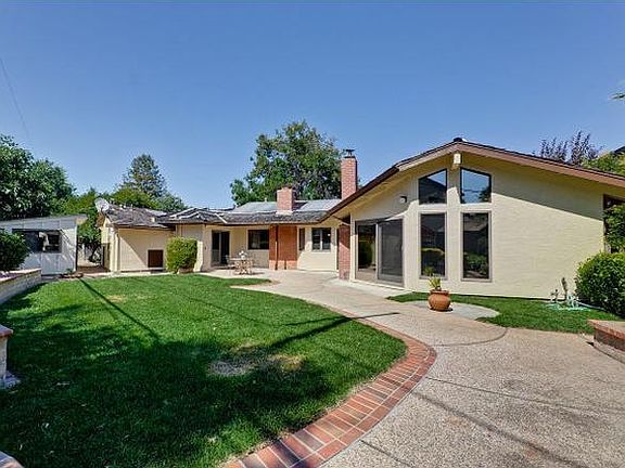 Lush green spacious backyard with storage room