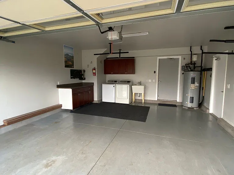 2 car garage with laundry, work bench and multiple surf racks