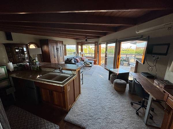 Cozy open wood interior with private deck and full view of Bay and Ocean