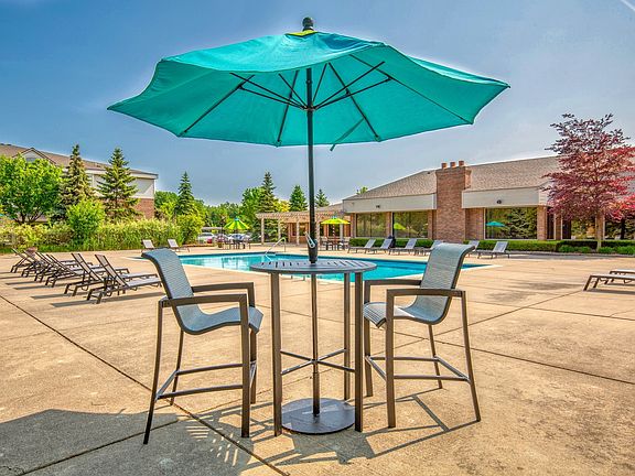 Heated Swimming Pool with lounge furniture at Prentiss Pointe Apartments in Harrison Township, MI