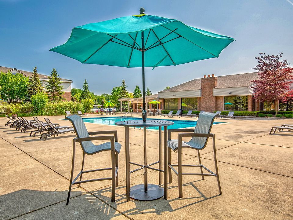 Heated Swimming Pool with lounge furniture at Prentiss Pointe Apartments in Harrison Township, MI