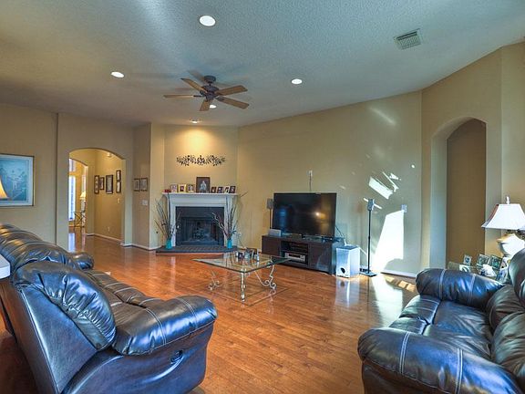Looking back into Den, shows the lovely wood floor, back corner fireplace with gas logs and pretty s