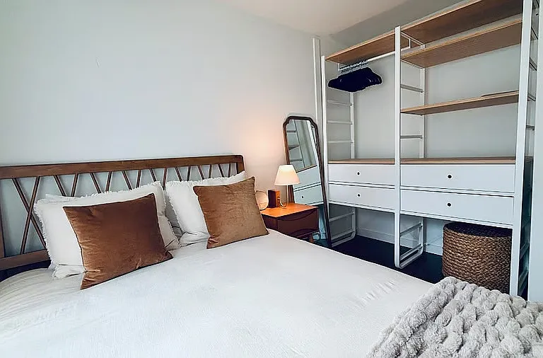 Bedroom includes open closet system with ample storage, shelving, and drawers