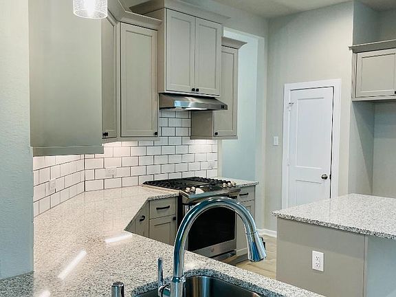 Brand New Stainless Steel Appliances. Upgraded white sketches backsplash.