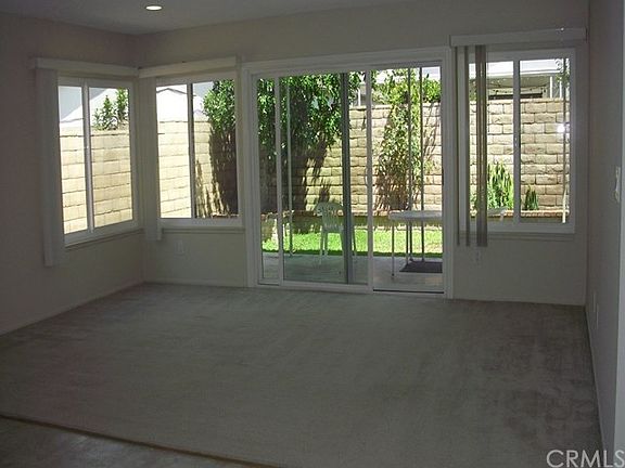 family room with carpet and new windows/ sliding door