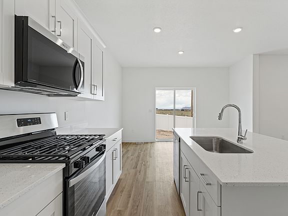 The kitchen has sprawling quartz countertops.