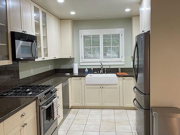 Spacious kitchen with newer stainless steel appliances and window over the sink