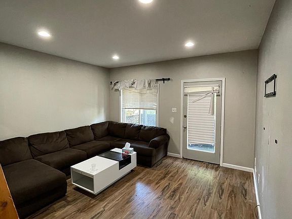 A view of the living room from the kitchen, the door leads to one of two decks the property offers