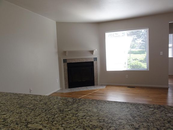 Living room with woodburning fireplace.