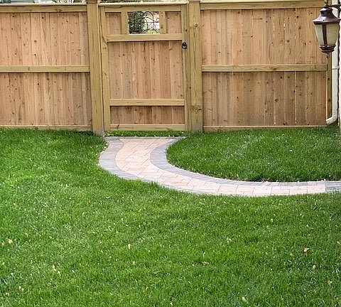 Backyard walkway to pedestrian door to garage
