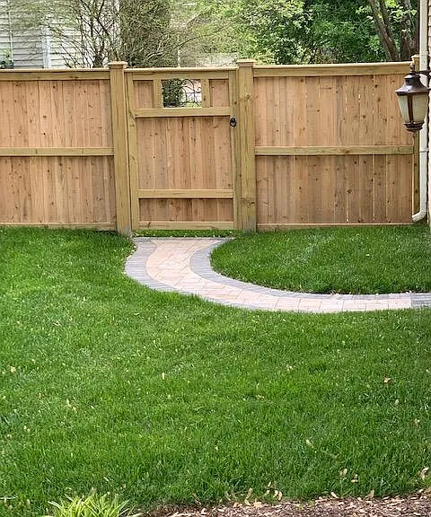 Backyard walkway to pedestrian door to garage