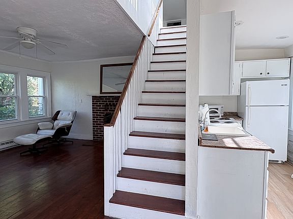 Living Room (l) with Kitchen (r) and Stairs to 2nd Floor Den (c)