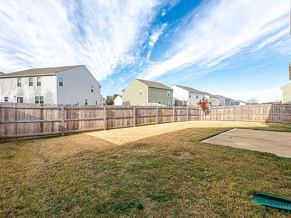 Additional view of backyard with back patio.
