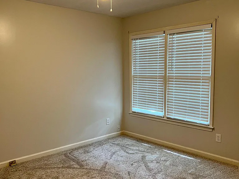 Second of three bedrooms with carpet and ceiling fan