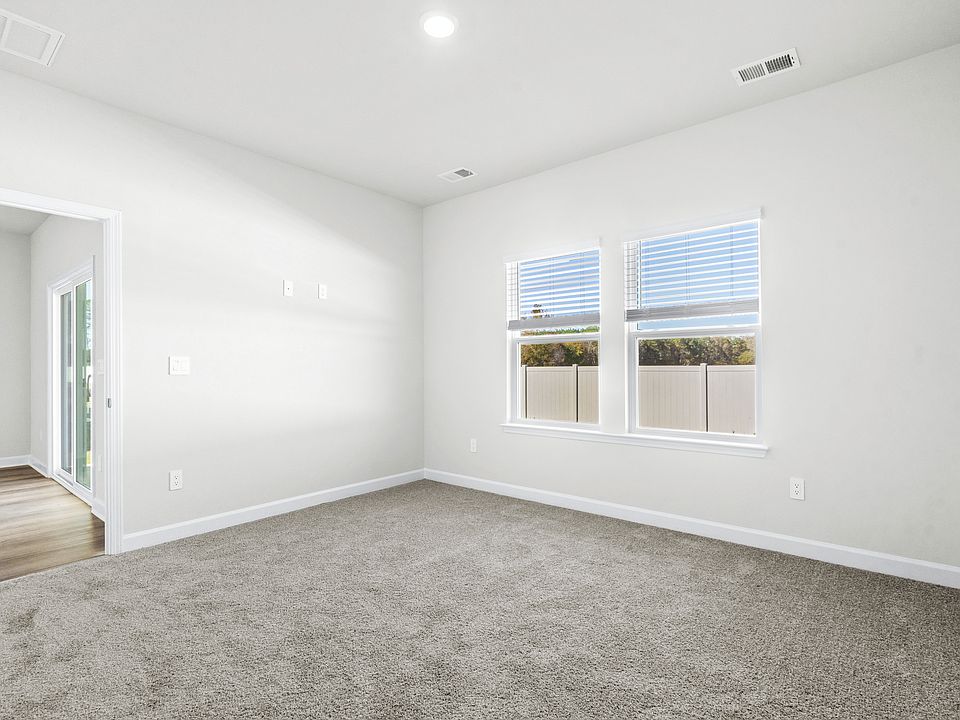 Relax and recharge in the spacious, light-filled primary suite.