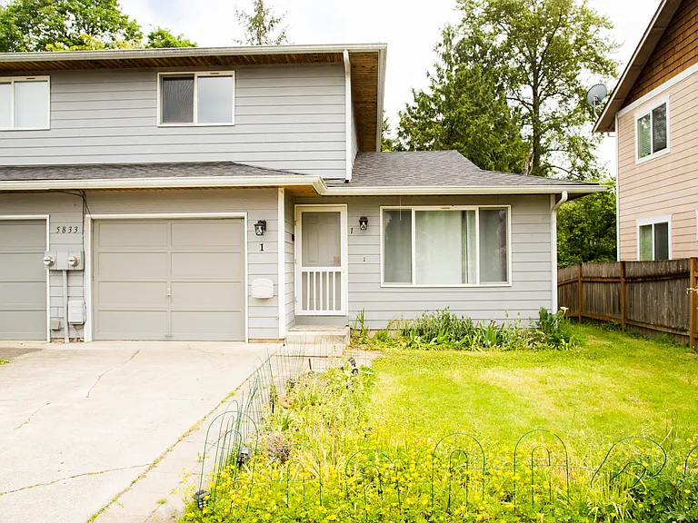 Front exterior with clean curb appeal, attached garage, and spacious front yard in a quiet residential setting.