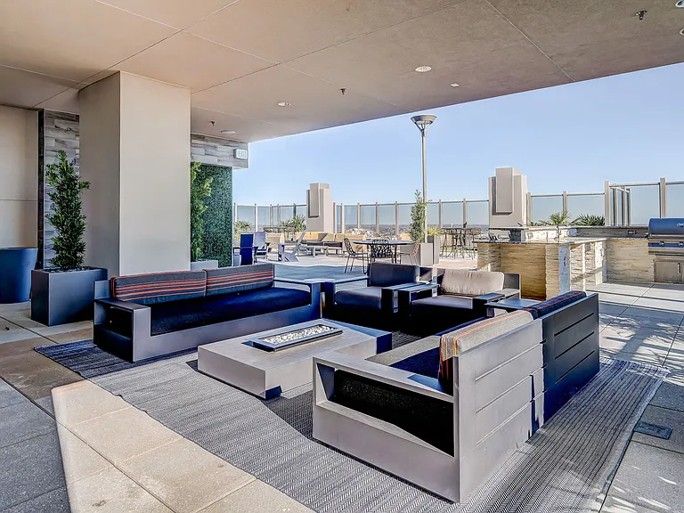 Rooftop lounge seating with fireplace and TV for entertainment