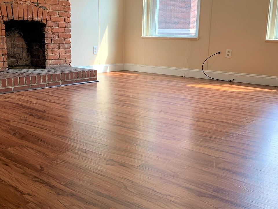 Living room with exposed brick wall/fireplace