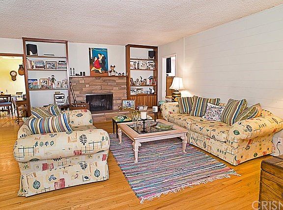 The spacious living room with wood burning fireplace.