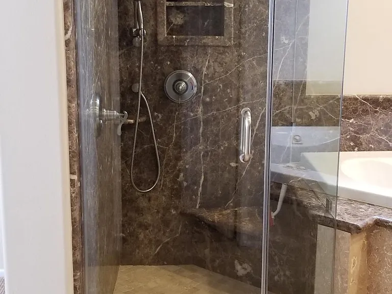 Master Bathroom Marble wall shower with Peruvian Travertine tile floors, seamless shower glass